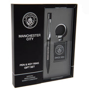 Manchester City gavesæt med pen og nøglering i sort emballage med klublogo og "SINCE 1894".