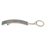 Metal nøglering med "MAN CITY" og logo i blå, integreret oplukker og nøglekæde.