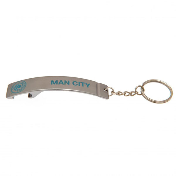 Metal nøglering med "MAN CITY" og logo i blå, integreret oplukker og nøglekæde.