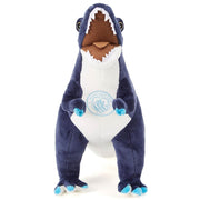 Blå og hvid T-rex bamse med Manchester City logo på brystet og åben mund.