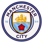 Rundt Manchester City klistermærke med logo, skib, rød rose på hvid baggrund.