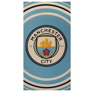 Manchester City håndklæde med klublogo på blå baggrund og hvide samt sorte buede striber.