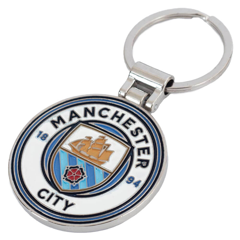 Sølvfarvet nøglering med Manchester City logo, skib, rose og årstal 1894 i blå-hvidt design.