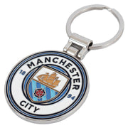 Sølvfarvet nøglering med Manchester City logo, skib, rose og årstal 1894 i blå-hvidt design.