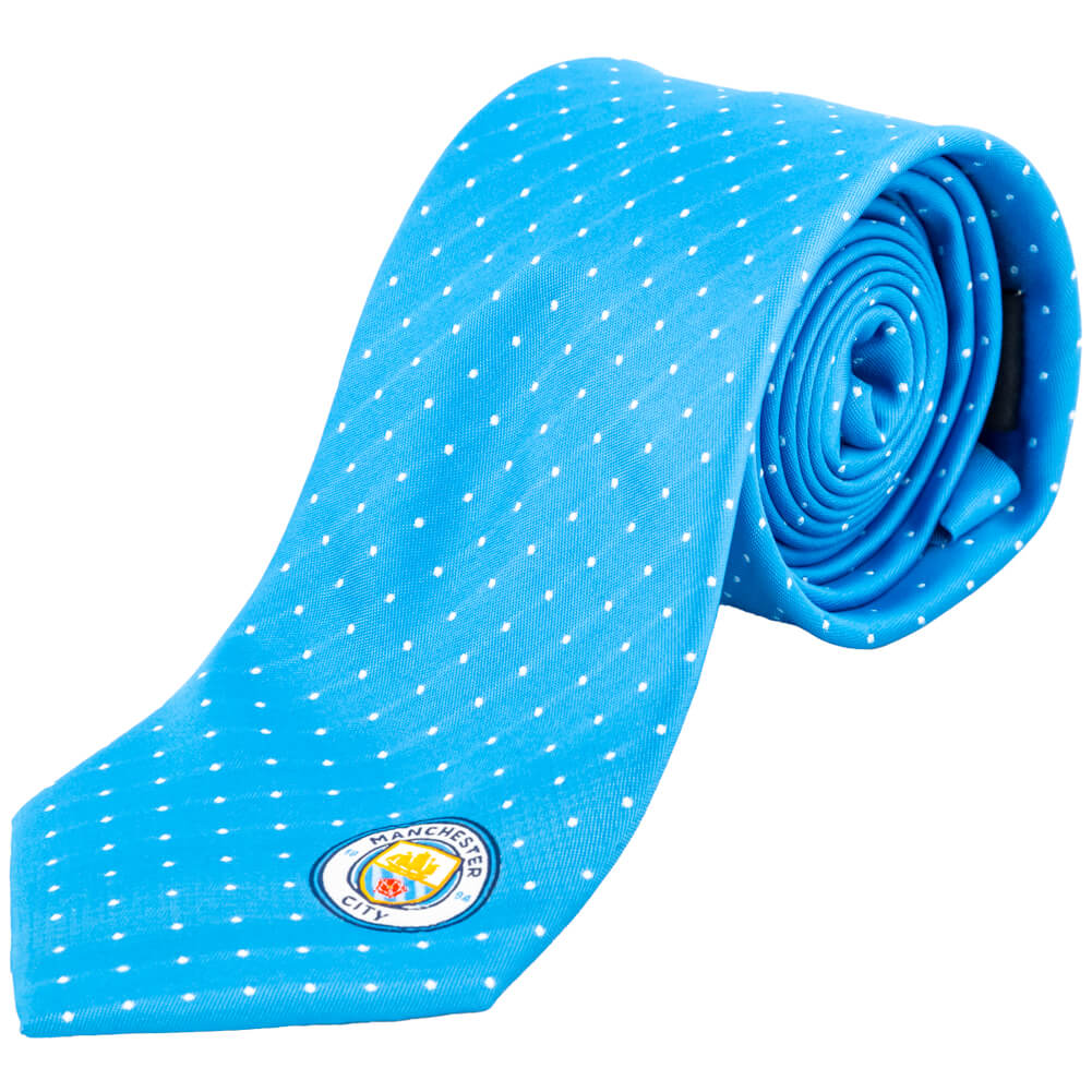 Lyseblåt slips med hvide prikker og Manchester City-logo nederst.