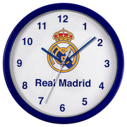 Vægur med blå kant, hvid urskive, Real Madrid logo, og teksten "Real Madrid". Diameter: 24 cm.