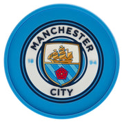 Rund ølbrik med blå kant, Manchester City FC logo med skib, rød rose og teksten "Manchester City".