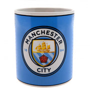 Blå krus med Manchester City FC-logo, der viser skib og rød rose.